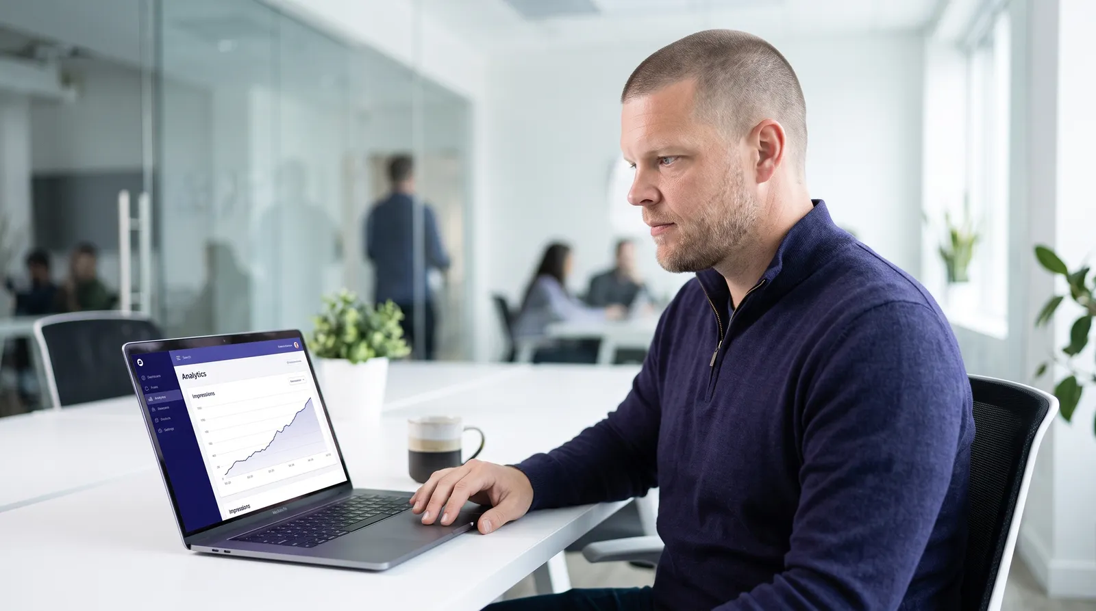 Mike Moore, founder of Strategic AI Architects, looking at a laptop screen showing an analytics dashboard with an Impressions line climbing upward, representing Google Search Console's new AI performance report